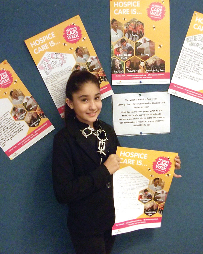 Indira holding her Hospice Care week poster. On the poster she wrote about the Hospice and what it means to her.