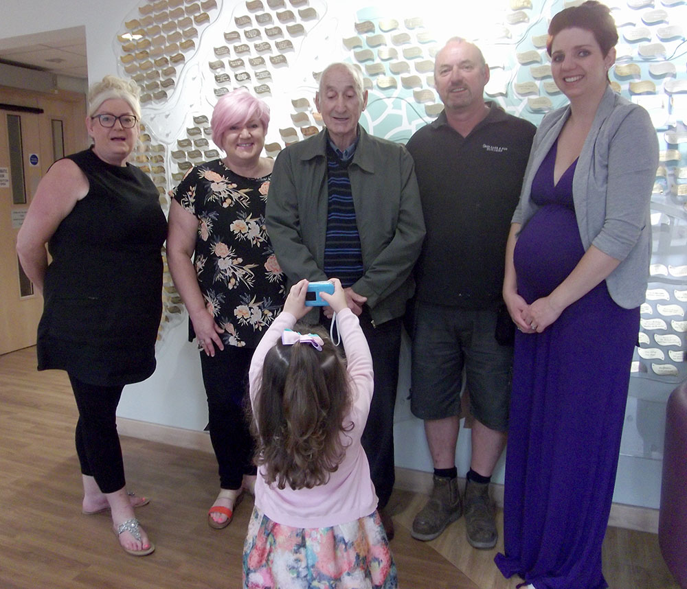 The family of Margaret Carr visit Woodlands Hospice Tree of Life to place their leaf on it