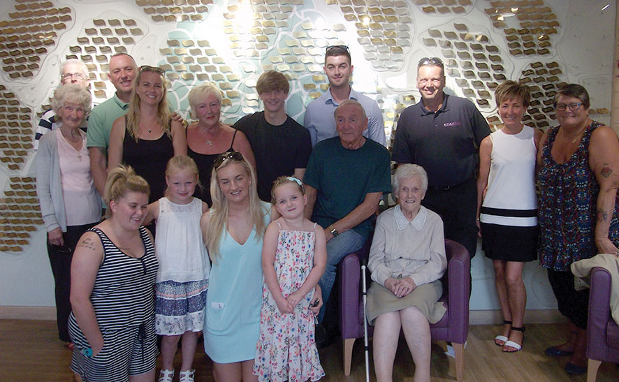 The Horrocks family standing by the Tree of Life at Woodlands Hospice